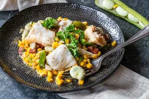 Cod, sweetcorn and broad beans succotash Stock Photos