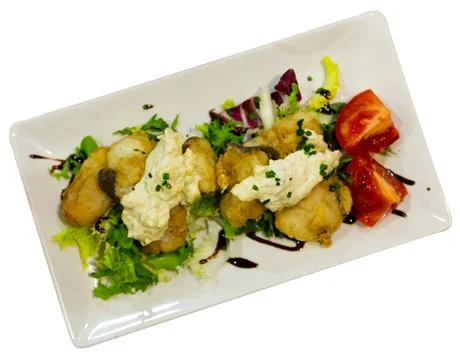 Cod with tartar sauce and herbs on served table Stock Photos
