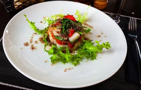 Cod timbale with baked red pepper, rocket and olive tapenade Stock Photos