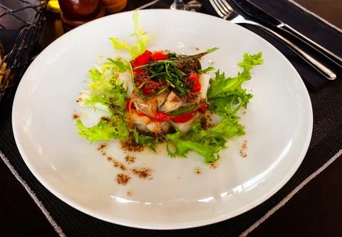 Cod timbale with roasted red peppers, arugula and olives Stock Photos