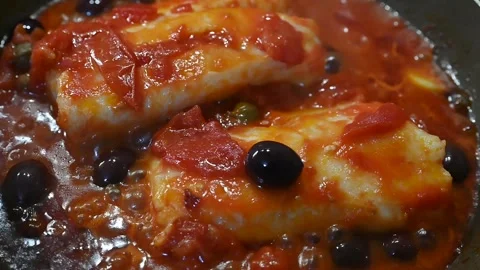 Cod in tomato sauce with black olives and capers (3) Stock Footage 294588746