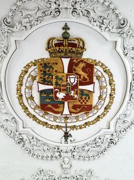 Code of Arms with intricate framing designs on the ceiling Stock Photos