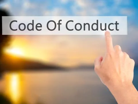 Code Of Conduct - Hand pressing a button on blurred background concept on vis Stock Photos