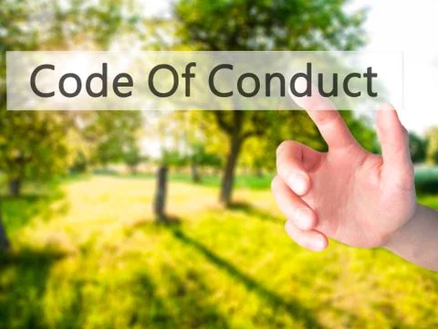 Code Of Conduct - Hand pressing a button on blurred background concept on vis Foto stock