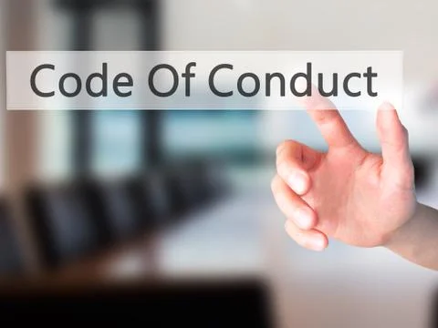 Code Of Conduct - Hand pressing a button on blurred background concept on vis Stock Photos