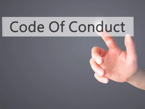 Code Of Conduct - Hand pressing a button on blurred background concept on vis Stock Photos