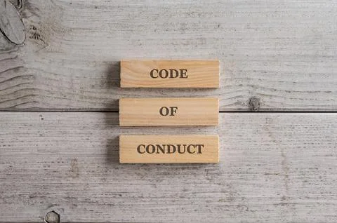 Code of conduct sign spelled on a stack of three wooden blocks Foto stock