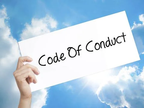 Code Of Conduct Sign on white paper. Man Hand Holding Paper with text. Iso... Stock Photos