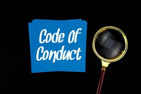 Code Of Conduct text on sticky note with magnifying glass on black background Stock Photos