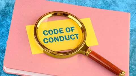 CODE OF CONDUCT words written on a yellow business card with a magnifying g.. 스톡 사진