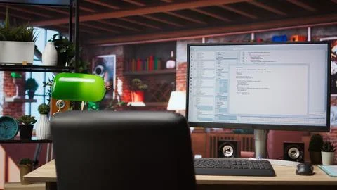 Code editor on computer screen in home office used for building applications Stock Photos