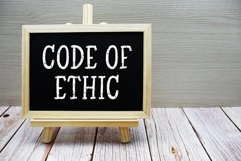 Code Of Ethic text written on chalkboard with easel on wooden background Foto stock