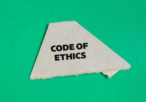 Code of ethics lettering on ripped paper piece with green background Stock Photos