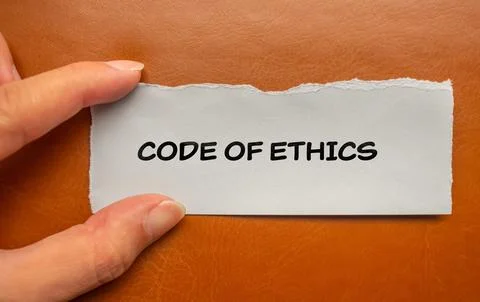 Code of ethics lettering on ripped paper piece with brown background Stock Photos