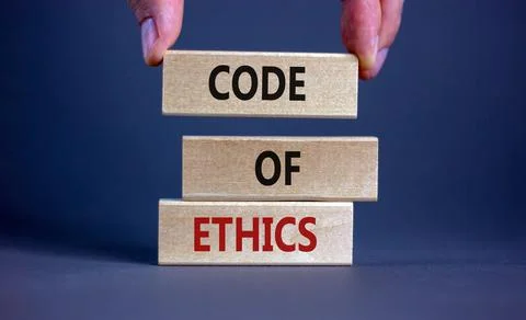 Code of ethics symbol. Concept words 'Code of ethics' on wooden blocks on a b Stock Photos
