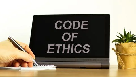 Code of ethics symbol. Tablet with words 'code of ethics'. Businessman hand w 写真素材