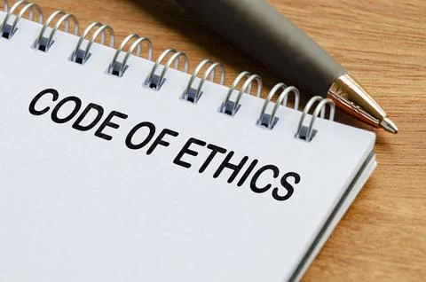 Code of ethics text on white notepad. Business code of ethics concept Stock Photos