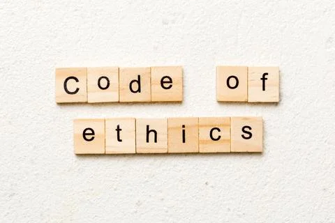 Code of ethics word written on wood block. code of ethics text on table, conc Foto stock