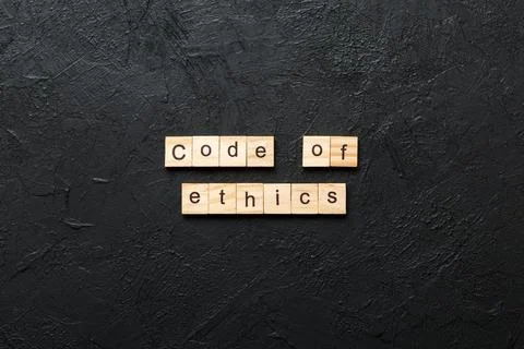 Code of ethics word written on wood block. code of ethics text on table, conc Foto stock
