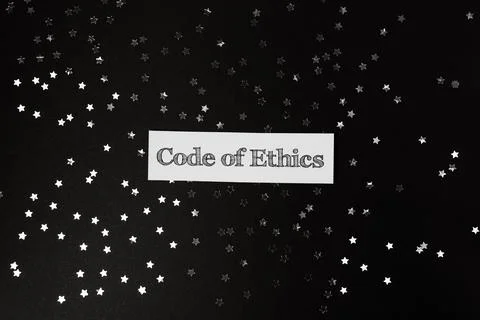 Code of ethics is written on a black background with a star pattern Stock Photos