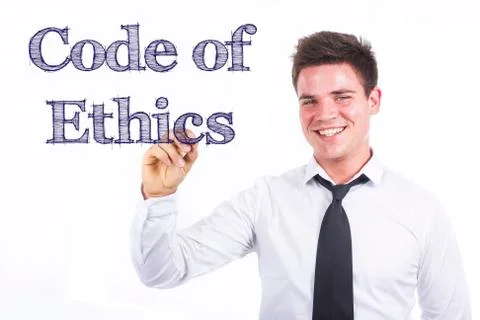 Code of Ethics - Young smiling businessman writing on transparent surface 写真素材