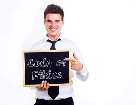 Code of Ethics - Young smiling businessman holding chalkboard with text Stock Photos