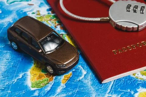 Code Lock on Red Passport, Toy Car, Pushpins on World Map Background. Concept Stock Photos