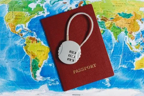 Code Lock on Red Passport on World Map Background. Concept-Ban on Travel, Lack Foto stock