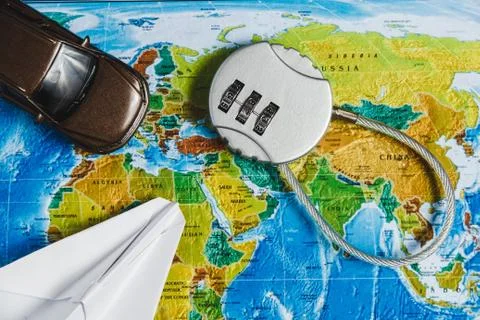 Code Lock, Toy Car, Papercraft Plane on World Map Background. Concept-Ban on Stock Photos