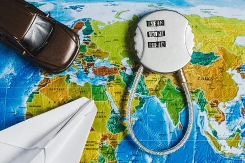 Code Lock, Toy Car, Papercraft Plane on World Map Background. Concept-Ban on Stock Photos