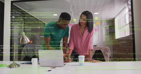 Code overlay appearing, two colleagues leaning, pointing, consulting laptop Stock Footage 334178314