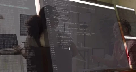 Code overlay appearing, two partners pointing and reading printed pages, Stock Footage 331833413