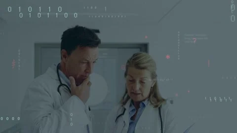 Code overlay fading, revealing two doctors leaning over blue folder in clinic, Stock Footage 333004475