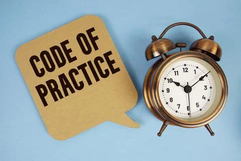 Code Of Practice text with alarm clock on blue background Stock Photos
