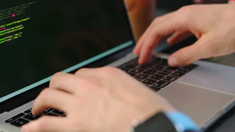 Code, programming and computer language with the hands of a coder or programmer Stock Footage 225551168