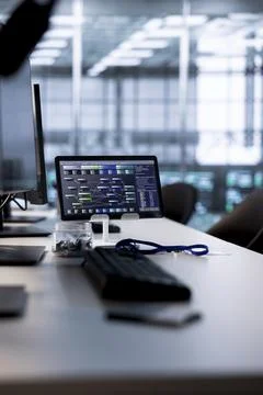 Code running on computer screens and tablet in empty data center 写真素材