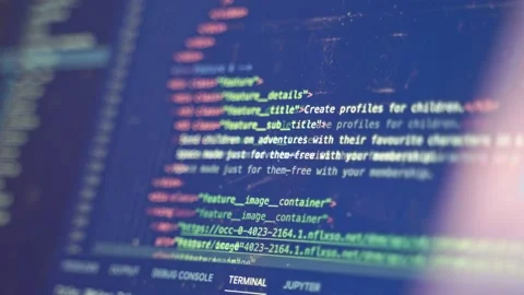 Code for a website is scrolled upward in an IDE as a programmer finds the Stock Footage 211934748