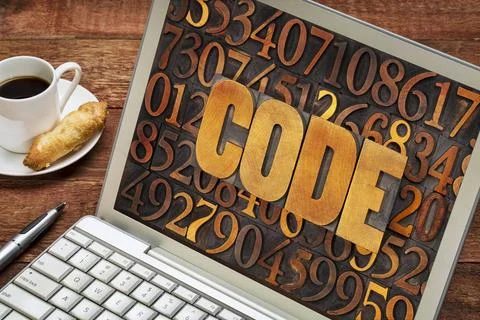 Code word abstract on a laptop screen code word in vintage letterpress woo... Stock Photos