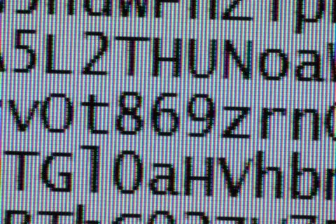 Coded digital letters background macro on tft monitor coded digital letter... Stock Photos