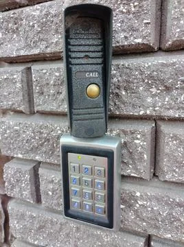 Coded electronic lock with numeric keypad on a brick wall Stock Photos