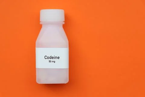 Codeine pill in white bottle, pill stock Stockfoto's