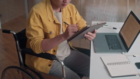Coder with Disability Testing Software App on Digital Tablet at Office Desk Stock Footage 265072621