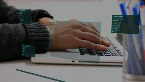 Coder hands typing on laptop first keystroke activating teal HUD panels around Stock Footage 333540060