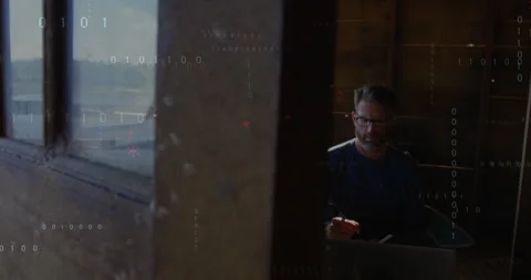 Coder typing C++ on laptop at cabin window as floating code overlay emerging for Stock Footage 311605191