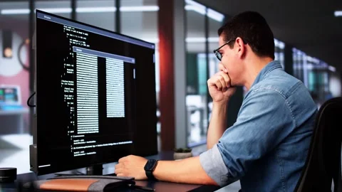Coder Using Computer At Desk Stock Footage 285197187
