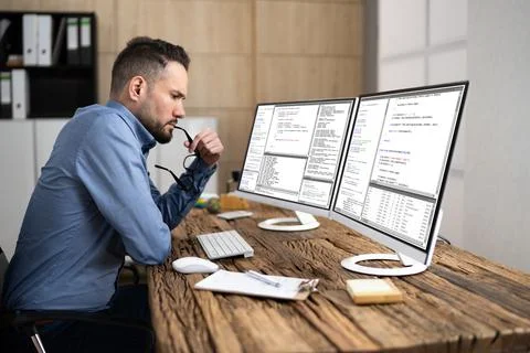 Coder Using Computer At Desk Foto stock