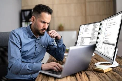 Coder Using Computer At Desk 写真素材