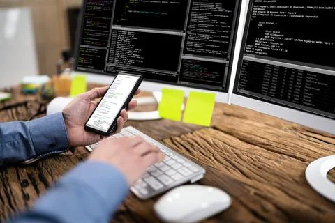 Coder Using Computer At Desk 库存照片