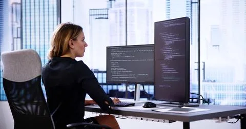Coder Using Computer At Desk 스톡 사진
