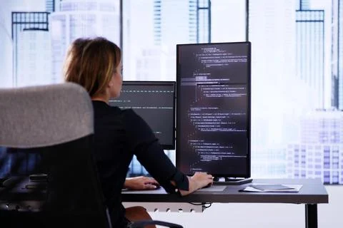 Coder Using Computer At Desk 库存照片